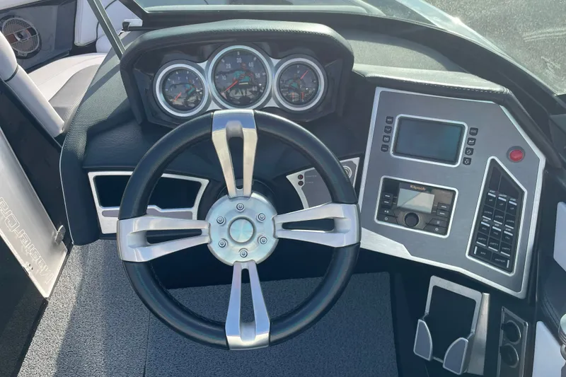 Slide: The Image of 2018 MasterCraft XT23 dashboard with steering wheel, gauges, and control panel. - 8