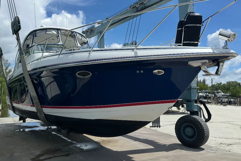 Slide: The Image of 2008 Formula 37 Performance Cruiser on lift, showcasing sleek design and blue hull. - 2