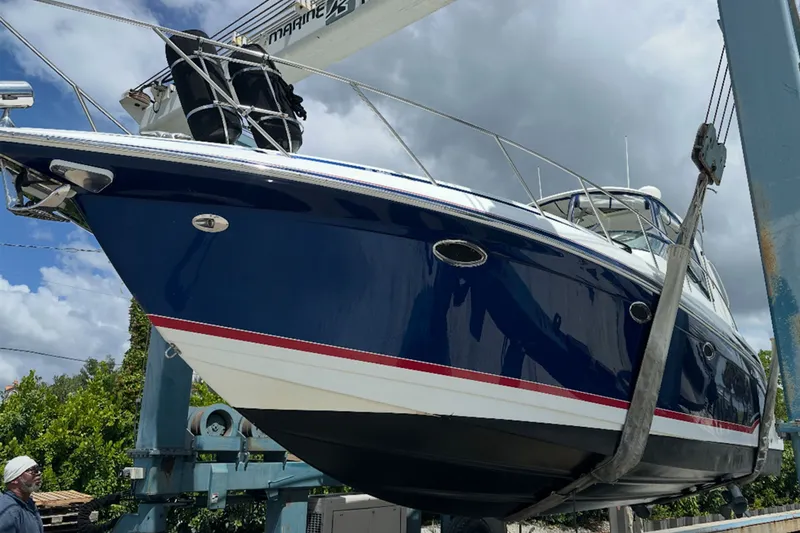 Slide: The Image of 2008 Formula 37 Performance Cruiser being lifted, showcasing sleek design and vibrant blue hull. - 1