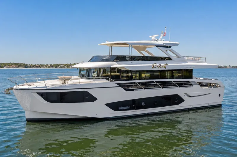 The Image of 2023 Absolute Navetta 75 yacht cruising on calm waters under a clear blue sky. - 0