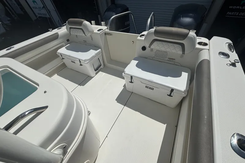 Slide: The Image of 2021 World Cat 295 CC boat interior with seating and storage coolers. - 25