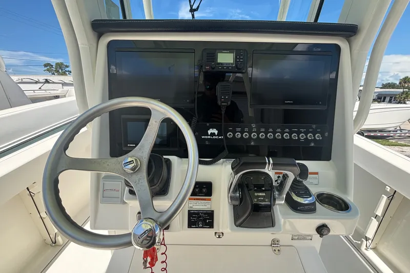 Slide: The Image of Helm of 2021 World Cat 295 CC boat with steering wheel and control panel. - 7