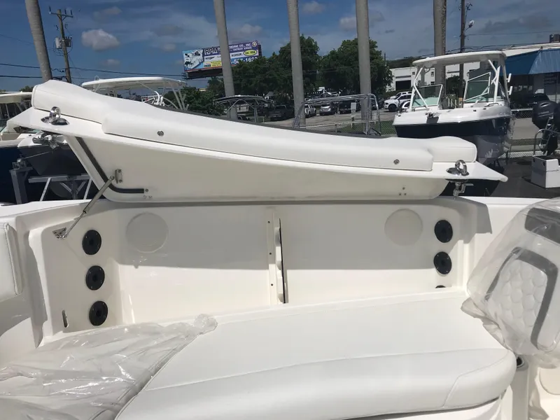 Slide: The Image of The image shows the cockpit of a 2021 World Cat 295 CC boat with white upholstery. - 29