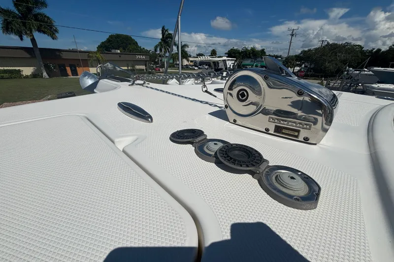 Slide: The Image of 2021 World Cat 295 CC boat deck with anchor and winch system under clear sky. - 27