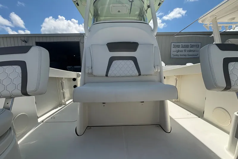 Slide: The Image of 2021 World Cat 295 CC boat interior with cushioned seating and modern design. - 17