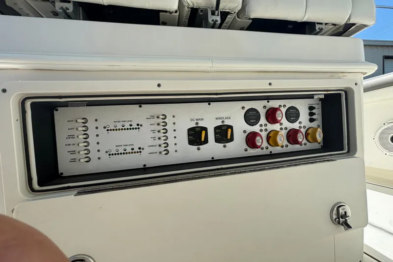 Slide: The Image of Control panel of a 2021 World Cat 295 CC boat, featuring switches and gauges. - 23