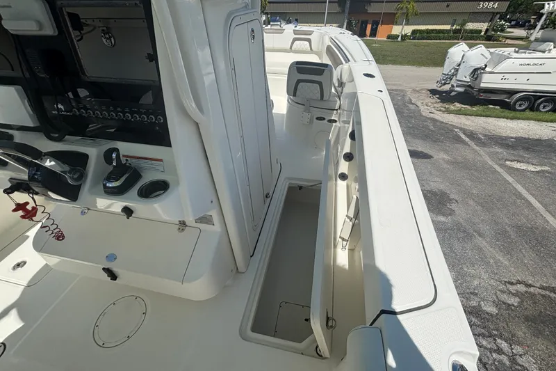 Slide: The Image of 2021 World Cat 295 CC boat interior with helm controls and seating area. - 12