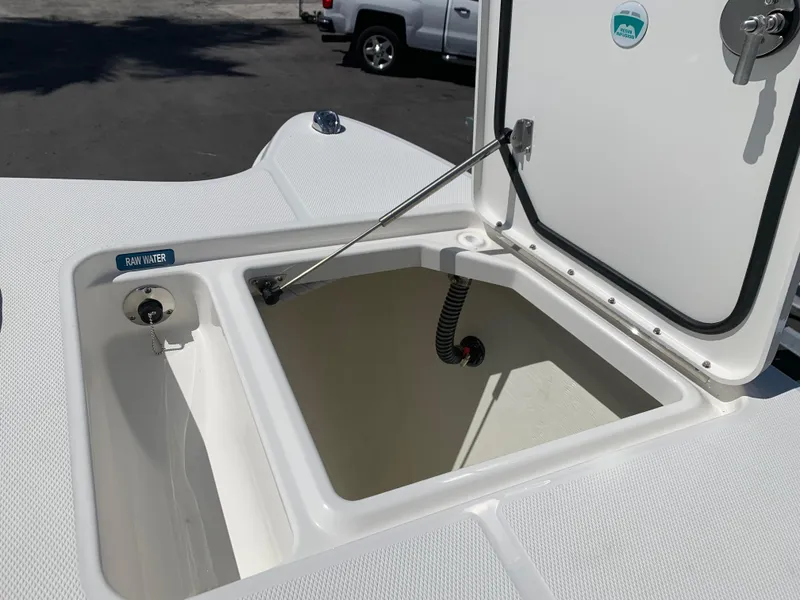 Slide: The Image of An open storage compartment on a 2021 World Cat 295 CC boat, featuring a water connection. - 22