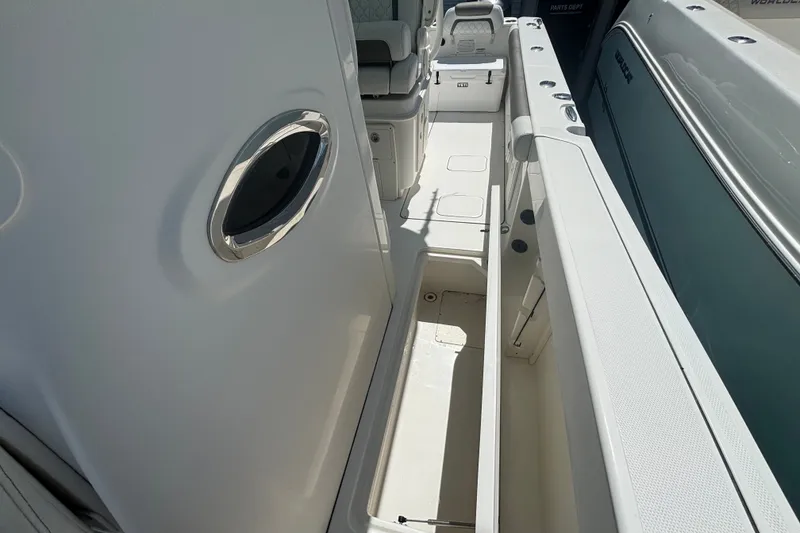 Slide: The Image of 2021 World Cat 295 CC boat interior, featuring sleek white deck and seating area. - 11