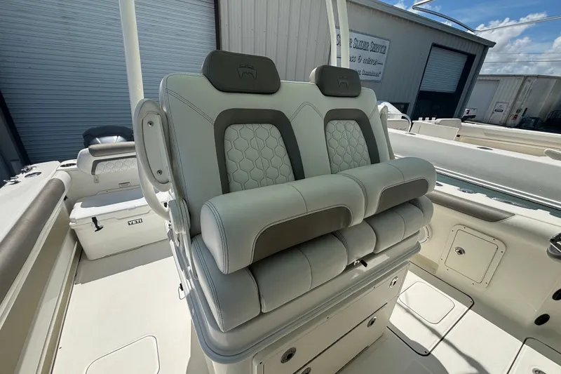 Slide: The Image of 2021 World Cat 295 CC boat interior with cushioned seating and storage compartments. - 9