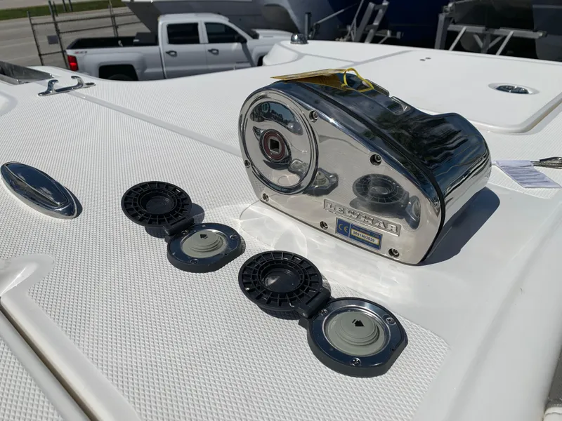 Slide: The Image of Close-up of a boat winch on a 2021 World Cat 295 CC, with several covers. - 26