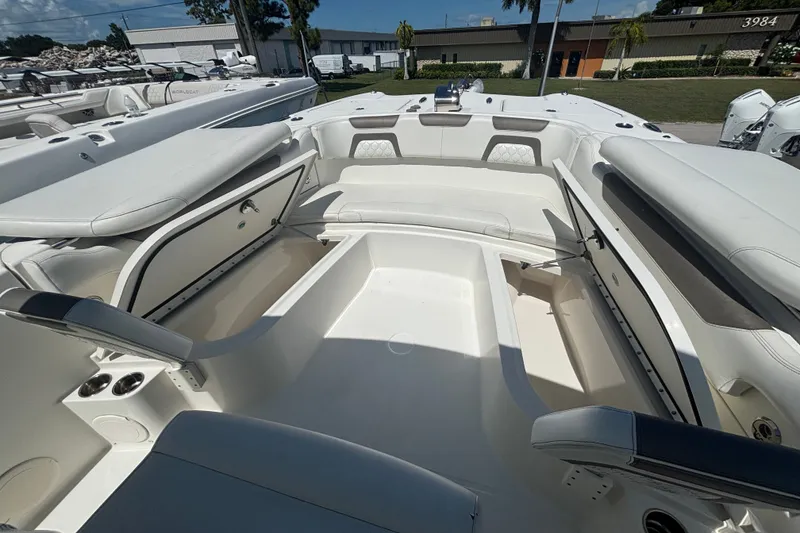 Slide: The Image of 2021 World Cat 295 CC boat interior with open storage compartments and seating. - 19