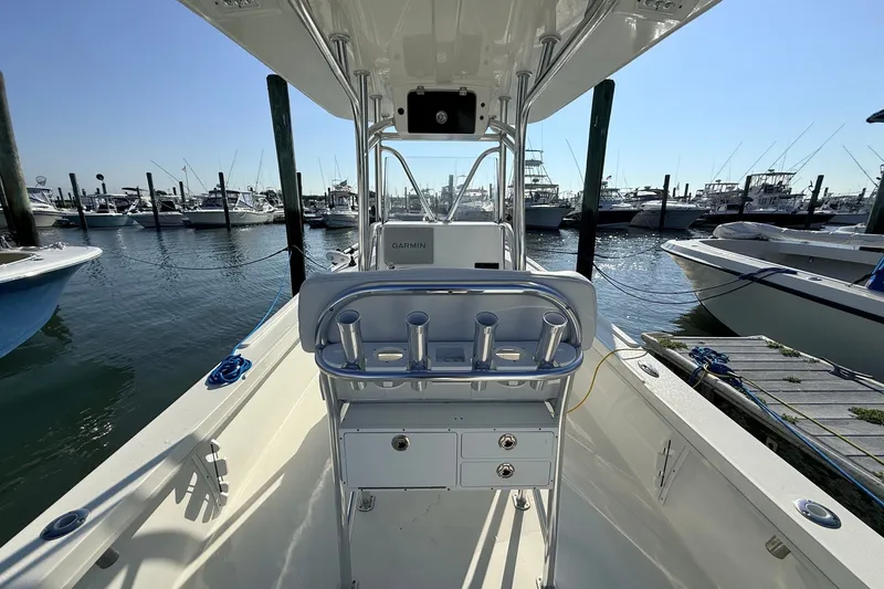 Slide: The Image of 2023 Pair Customs 24 Center Console DV boat docked at marina, featuring sleek design. - 14