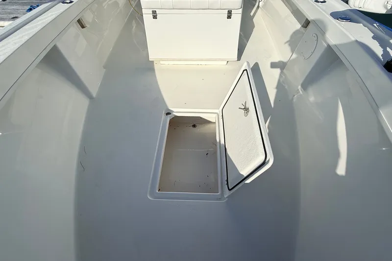 Slide: The Image of 2023 Pair Customs 24 Center Console DV boat interior with open storage compartment. - 19