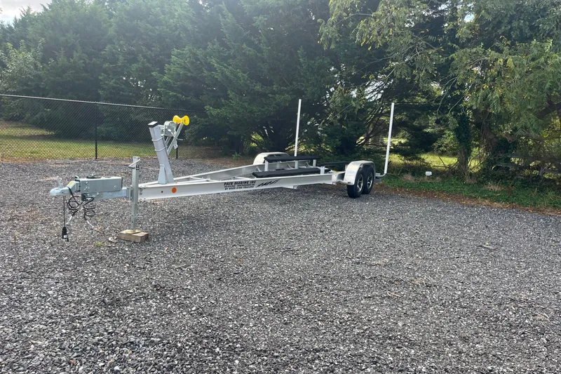 Slide: The Image of Trailer for 2023 Pair Customs 24 Center Console DV on gravel lot. - 13