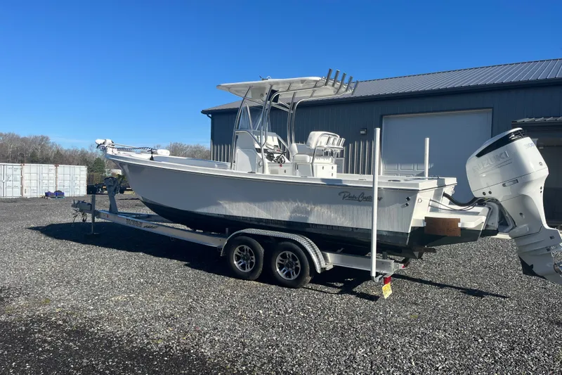 Slide: The Image of 2023 Pair Customs 24 Center Console DV boat on trailer, parked outdoors. - 5