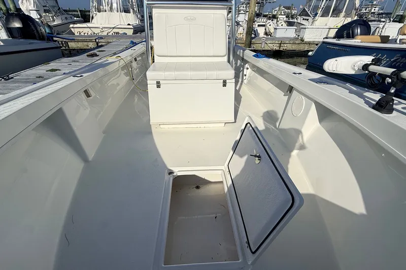Slide: The Image of 2023 Pair Customs 24 Center Console DV boat interior with open storage compartment. - 18