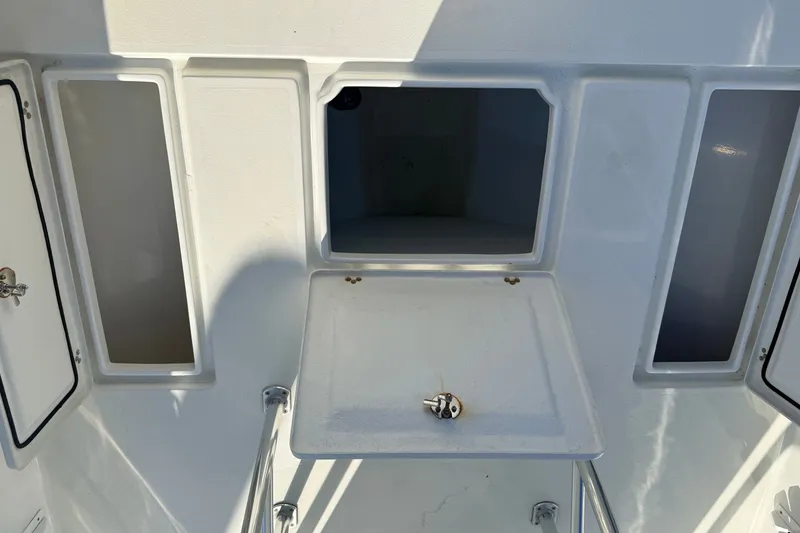 Slide: The Image of 2023 Pair Customs 24 Center Console DV boat interior with storage compartments. - 17