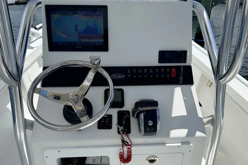 Slide: The Image of 2023 Pair Customs 24 Center Console DV dashboard with steering wheel and navigation display. - 6