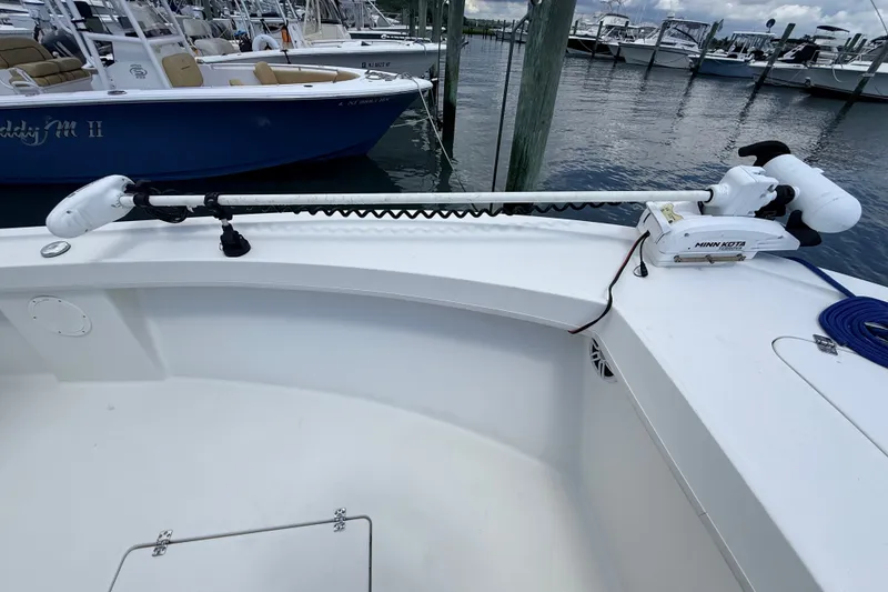 Slide: The Image of 2023 Pair Customs 24 Center Console DV with Minn Kota trolling motor at marina. - 10