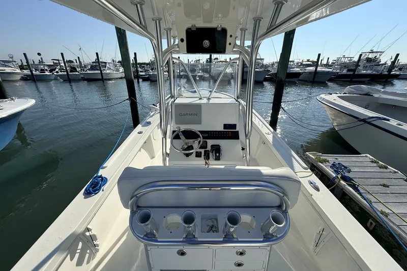 Slide: The Image of 2023 Pair Customs 24 Center Console DV boat docked at marina, featuring Garmin navigation. - 15