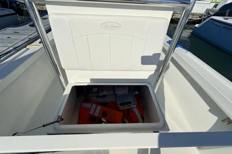 Slide: The Image of 2023 Pair Customs 24 Center Console DV boat storage compartment with life jackets and equipment. - 22