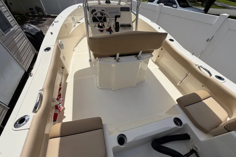 Slide: The Image of 2017 Scout 195 Sportfish boat interior with beige seating and steering console. - 9