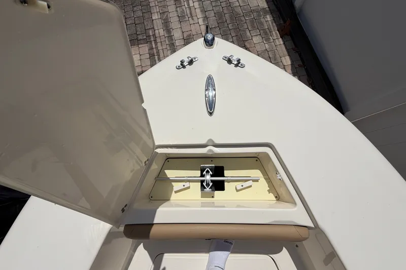 Slide: The Image of 2017 Scout 195 Sportfish boat anchor compartment open on deck. - 15