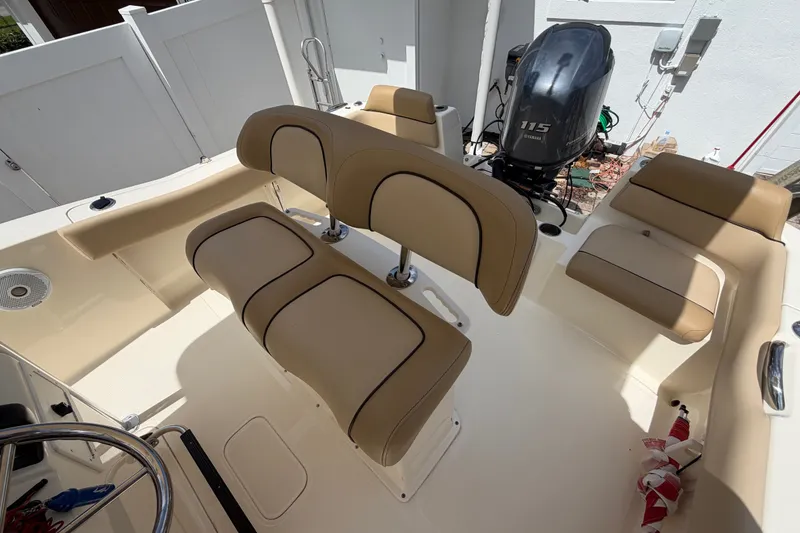Slide: The Image of 2017 Scout 195 Sportfish boat interior with tan seating and Yamaha 115 outboard motor. - 22