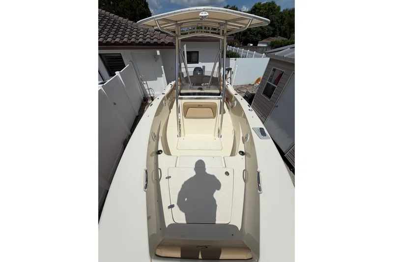 Slide: The Image of 2017 Scout 195 Sportfish boat with T-top, parked in a residential area. - 16