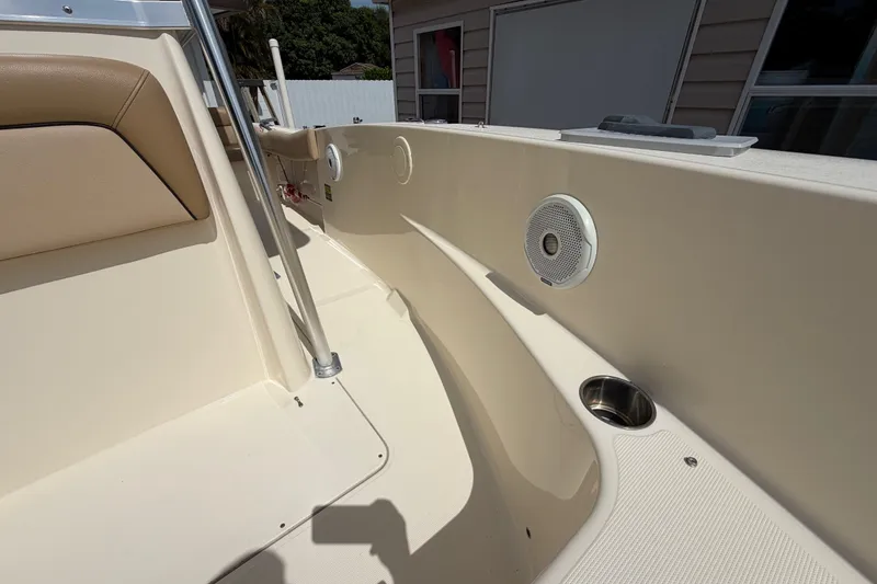 Slide: The Image of Interior view of a 2017 Scout 195 Sportfish boat, featuring seating and speaker. - 18