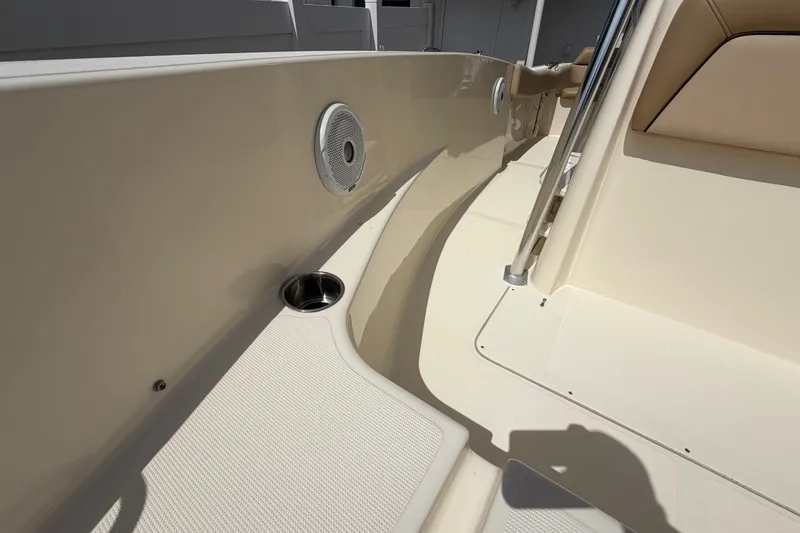 Slide: The Image of Interior view of a 2017 Scout 195 Sportfish boat, featuring seating and speaker. - 17