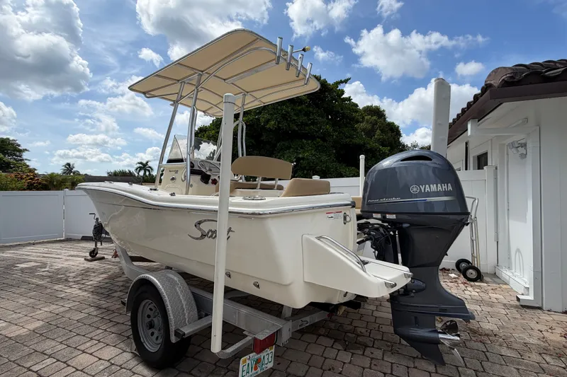Slide: The Image of 2017 Scout 195 Sportfish boat with Yamaha motor on trailer, parked outdoors. - 7