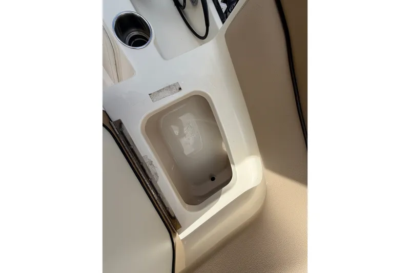 Slide: The Image of 2017 Scout 195 Sportfish boat interior detail with cup holder and storage compartment. - 25