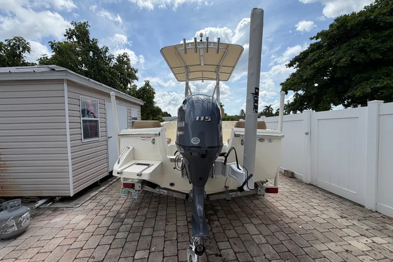 Slide: The Image of 2017 Scout 195 Sportfish boat with Yamaha 115 engine, parked on paved driveway. - 8