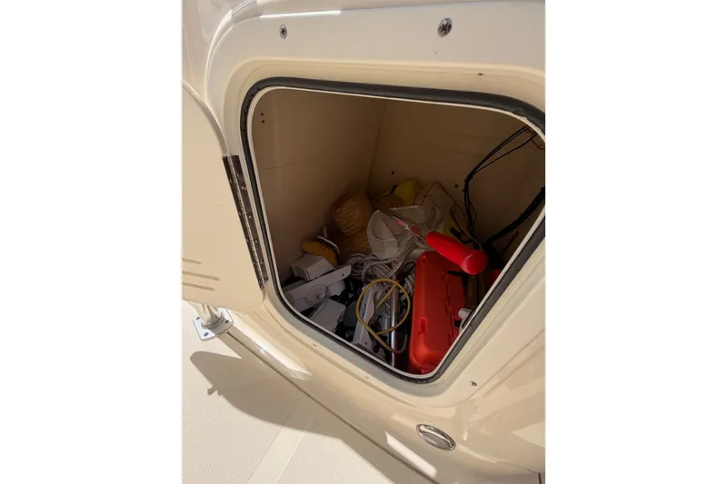 Slide: The Image of Storage compartment of a 2017 Scout 195 Sportfish boat with various equipment inside. - 27