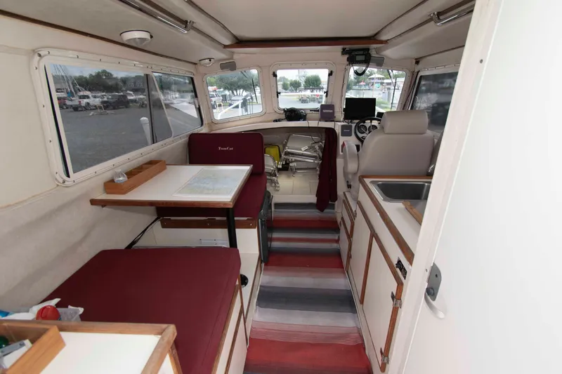 Slide: The Image of Interior of 2007 C-Dory 25' Tomcat Catamaran with seating, table, and helm. - 12
