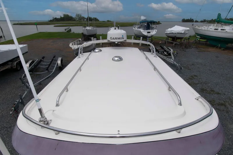 Slide: The Image of 2007 C-Dory 25' Tomcat Catamaran on trailer, docked near a serene waterfront. - 9
