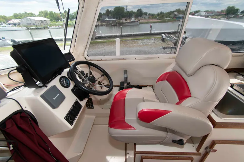 Slide: The Image of Interior helm of 2007 C-Dory 25' Tomcat Catamaran with steering wheel and navigation equipment. - 13