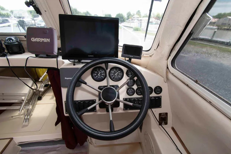 Slide: The Image of 2007 C-Dory 25' Tomcat Catamaran helm with Garmin navigation and Raymarine controls. - 15
