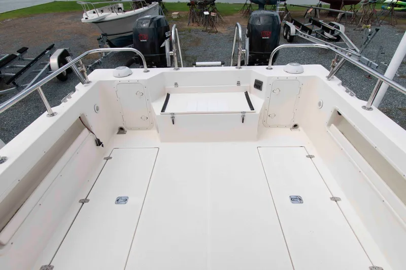 Slide: The Image of 2007 C-Dory 25' Tomcat Catamaran deck with storage compartments and railing. - 5