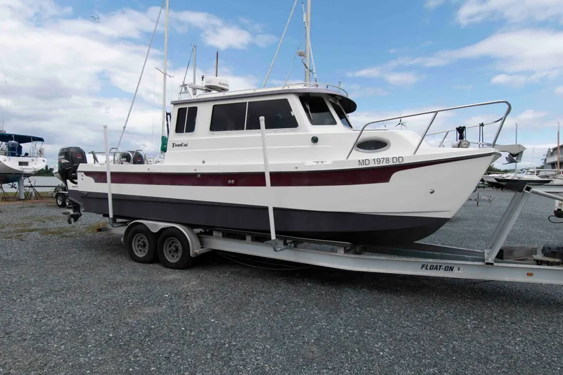 Slide: The Image of 2007 C-Dory 25' Tomcat Catamaran on trailer, parked in a marina setting. - 1