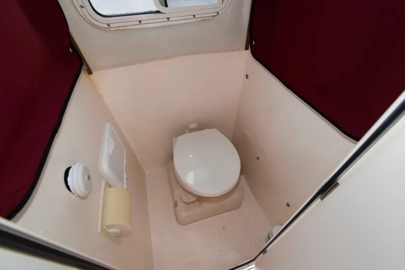 Slide: The Image of Compact marine toilet in 2007 C-Dory 25' Tomcat Catamaran, featuring white and maroon interior. - 20