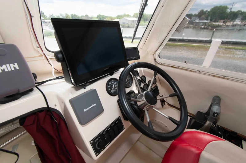 Slide: The Image of 2007 C-Dory 25' Tomcat Catamaran helm with Garmin and Raymarine electronics. - 14