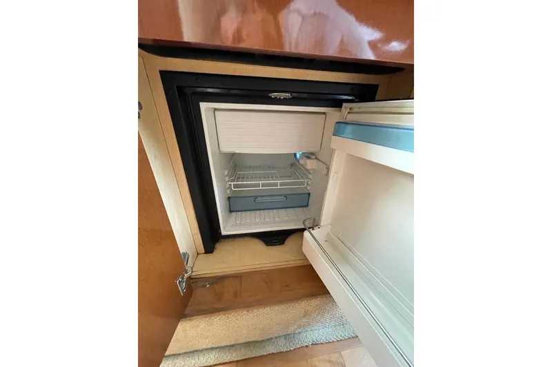 Slide: The Image of Compact refrigerator inside 2012 Sea Ray Sundancer 310 yacht, open door view. - 10