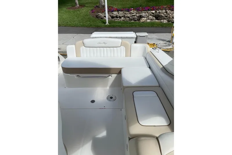 Slide: The Image of 2012 Sea Ray Sundancer 310 boat seating area with white and beige upholstery. - 18