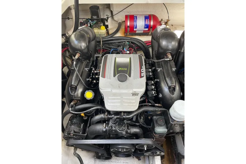 Slide: The Image of Engine compartment of a 2012 Sea Ray Sundancer 310 boat, featuring a 5.0L motor. - 20