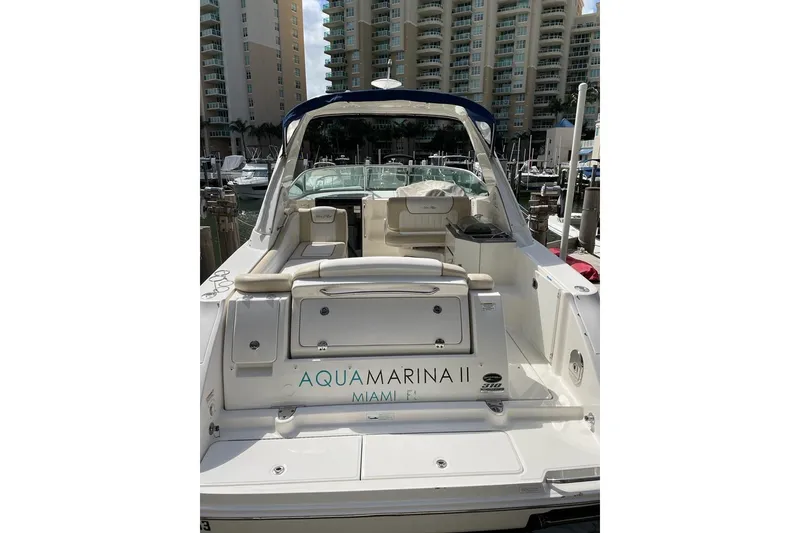 Slide: The Image of 2012 Sea Ray Sundancer 310 boat docked in marina, Miami, with luxury seating. - 4