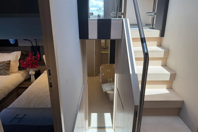 Slide: The Image of Interior of 2018 Azimut 66 Flybridge yacht, featuring elegant stairs and cozy bedroom. - 29