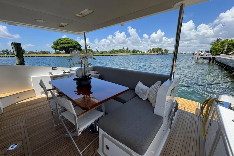 Slide: The Image of Luxurious 2018 Azimut 66 Flybridge yacht with elegant outdoor seating and scenic water views. - 15